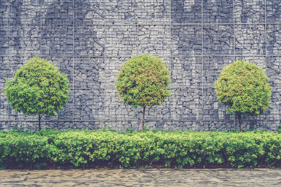 Dry-stacked fieldstone retaining wall with battered face and cap course
