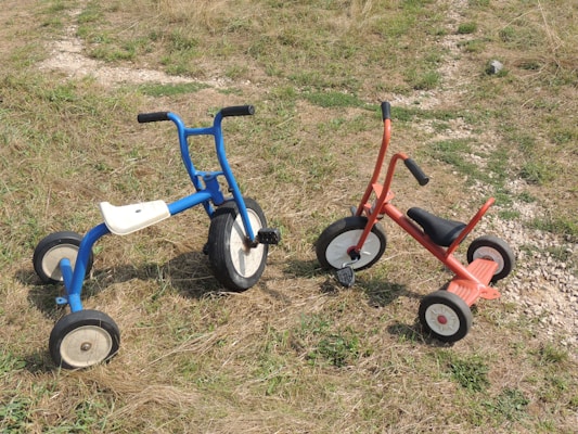 A collection of colorful tricycles for children.