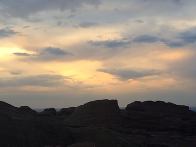 Sunset casting warm orange hues over rocky canyon formations.