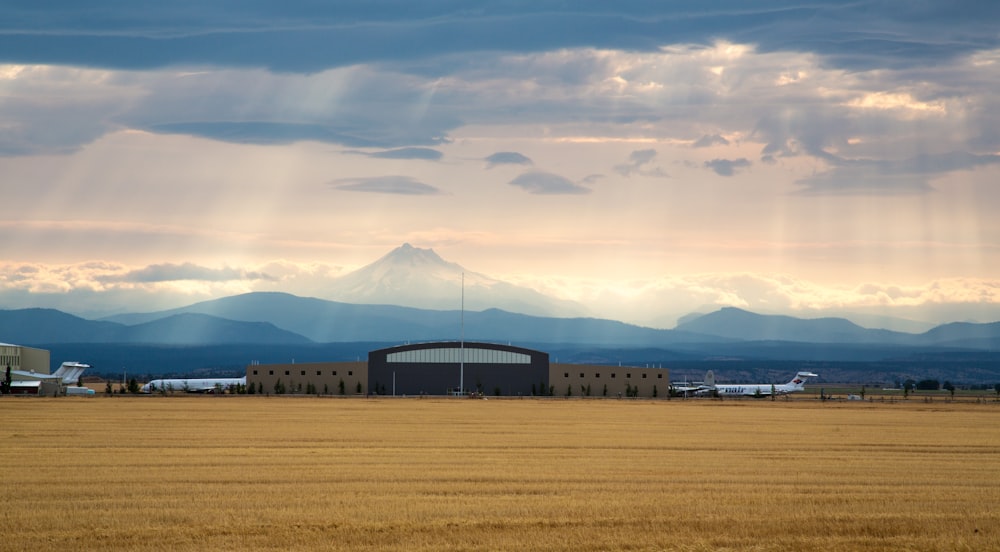 mountain in-front brown farm during daytime