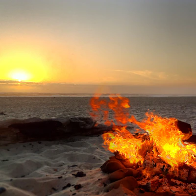 A warm sunset over a safari camp with guests enjoying a cozy fire.