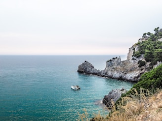 two boats near stone island during day