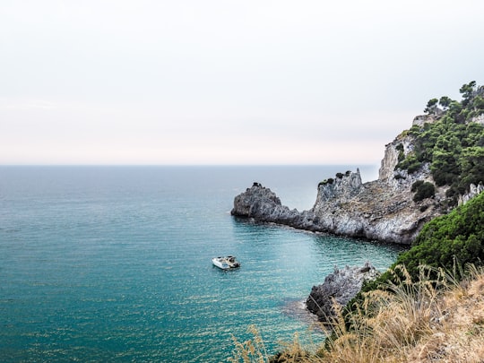 two boats near stone island during day in Sperlonga Italy