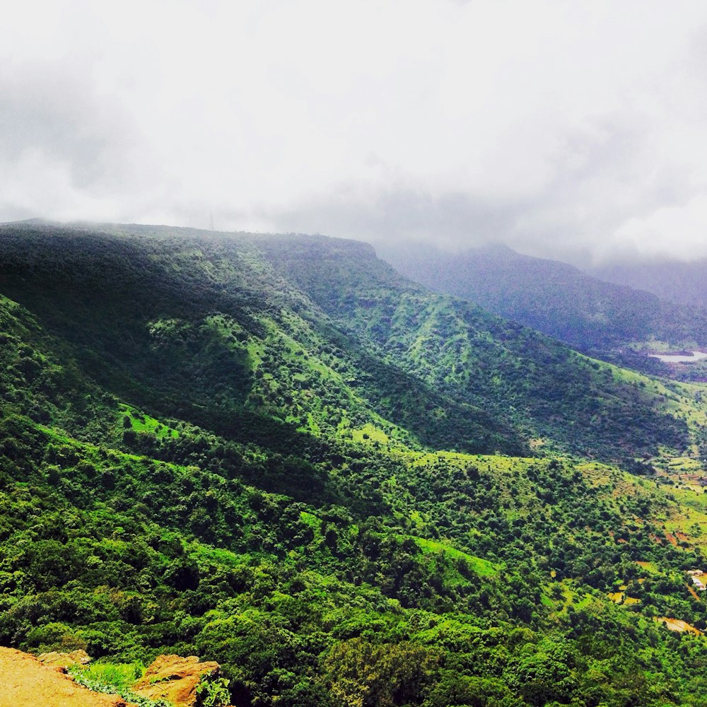 green mountain under white clouds