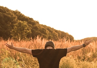 man standing in the middle of field