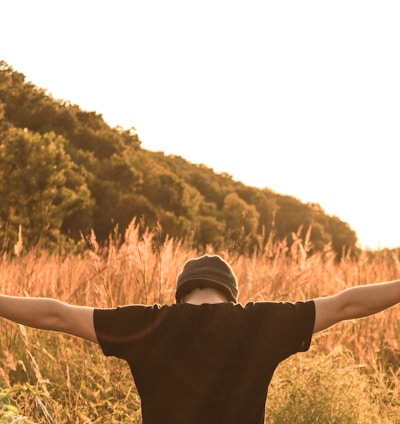 man standing in the middle of field