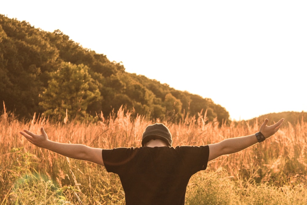 man standing in the middle of field