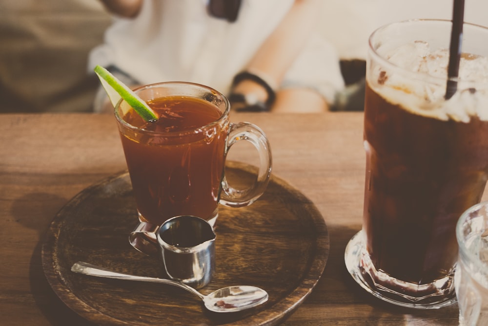 clear glass mug filled with brown liquid