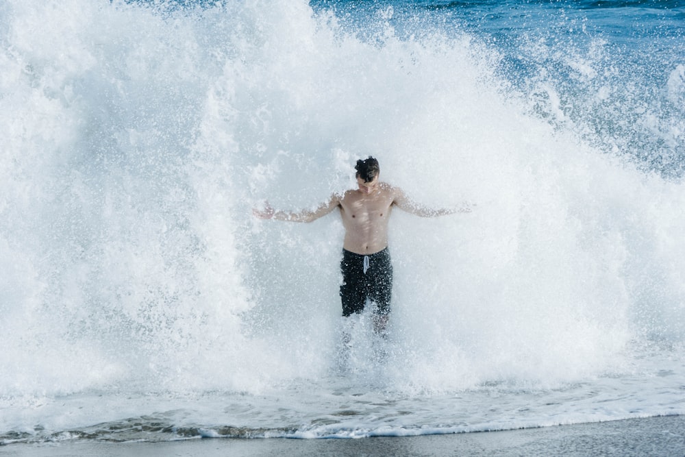 man standing against splashing water