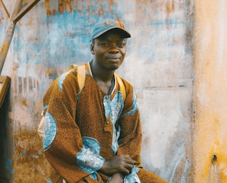 man sitting on chair near wall