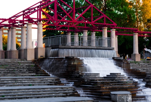 A cascading waterfall feature integrated into a landscaped outdoor space.