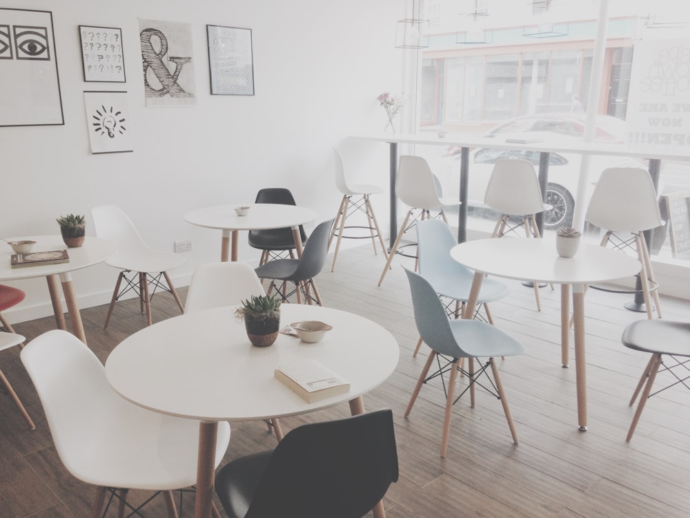 minimalist photography of white table and chairs resto