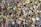 A large collection of various rings scattered on a dark surface. The rings display a variety of designs, with some featuring turquoise stones, intricate patterns, and metallic finishes. Their colors range from gold and silver to bright blues and reds, creating an eclectic and vibrant assortment.