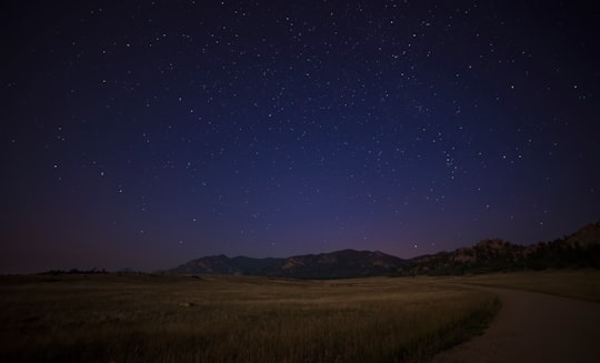 green grass field near mountain at night time photo in Colorado United States