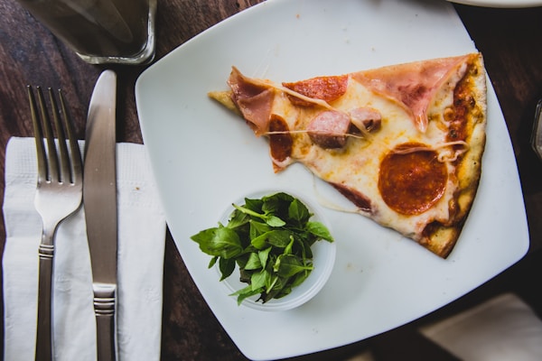 Sliced pepperoni pizza on plate