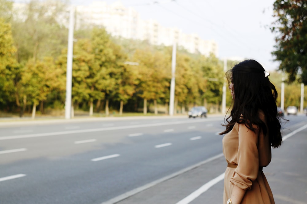 woman standing beside road