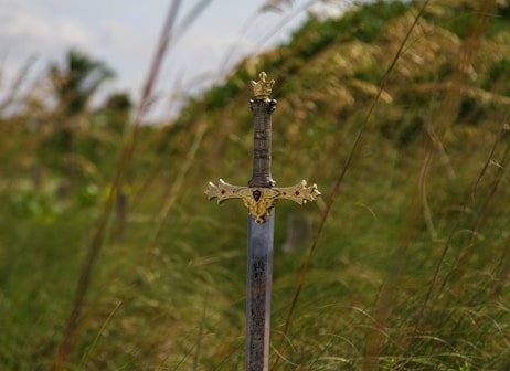 gray steel sword on ground during daytime