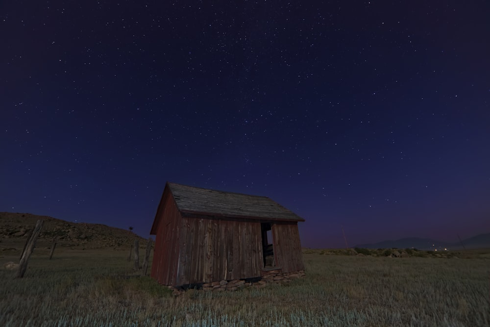 brown wooden shed on green grass field