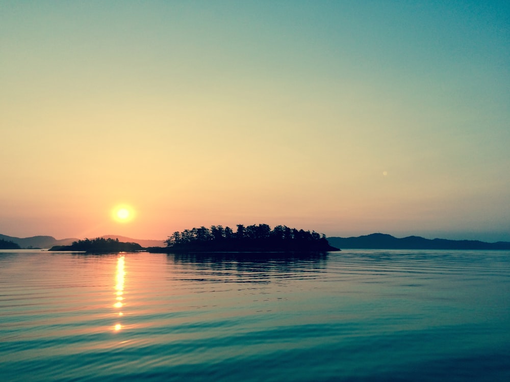 silhouette of island during golden hour