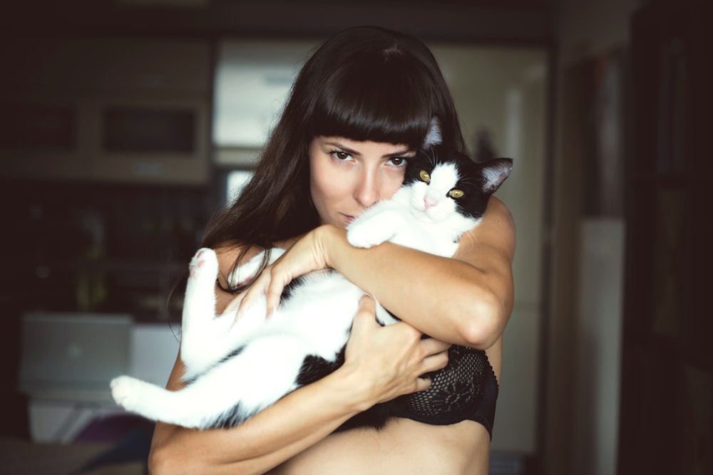 woman carrying cat