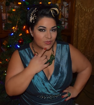 Elegant woman with party makeup posing in a festive setting.