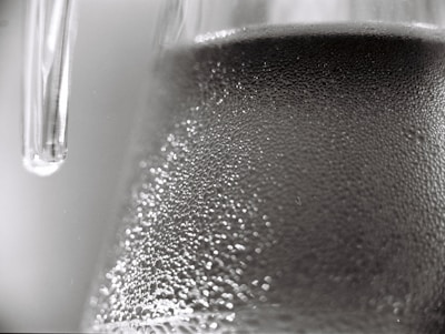 Close-up of sparkling clean glass with water droplets reflecting light.