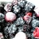 A close-up view of a variety of frozen berries, primarily consisting of blackberries and raspberries, with a light frost covering them.