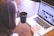 woman holding tea filled mug using MacBook