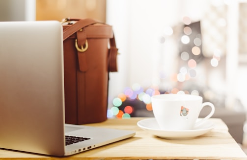 A calming image of a serene workspace with a laptop and a cup of tea.