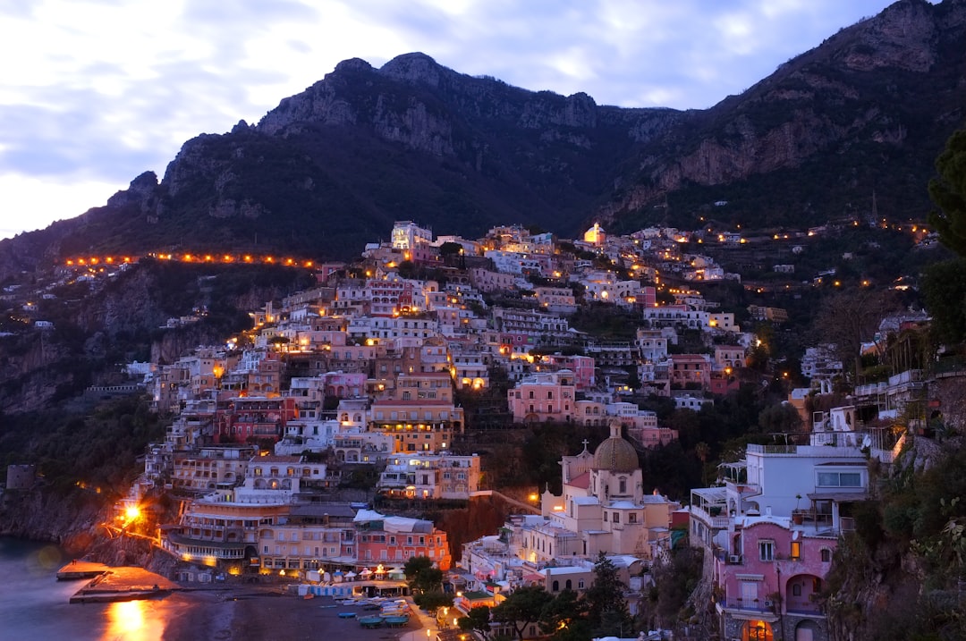 houses beside sea with mountain background, Evening falls on a mountain town