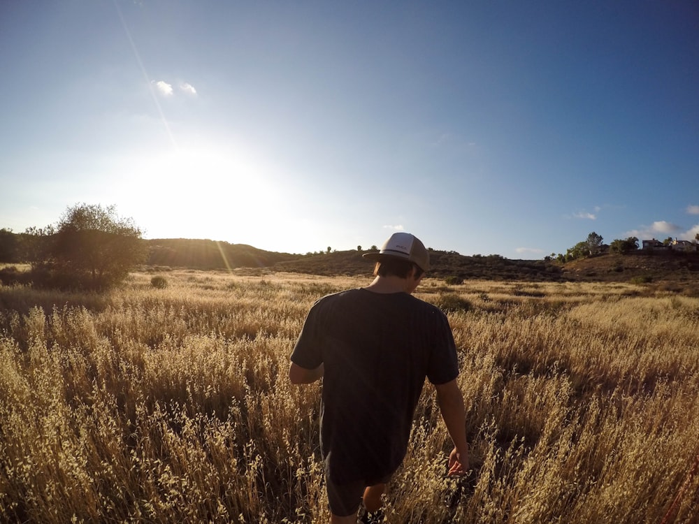 A man walking through a country field.