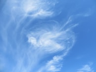 A whimsical depiction of clouds and a sunny sky.