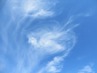 A whimsical sky castle floating among soft yellow clouds and light blue skies.