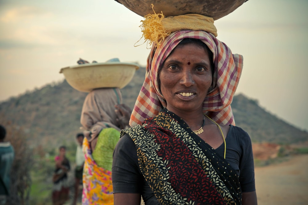 woman in black top with brown bowl on head