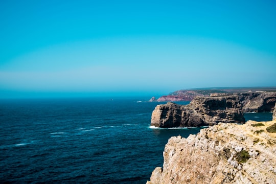 photo of rock formations near body of water in Cape St. Vincent Portugal