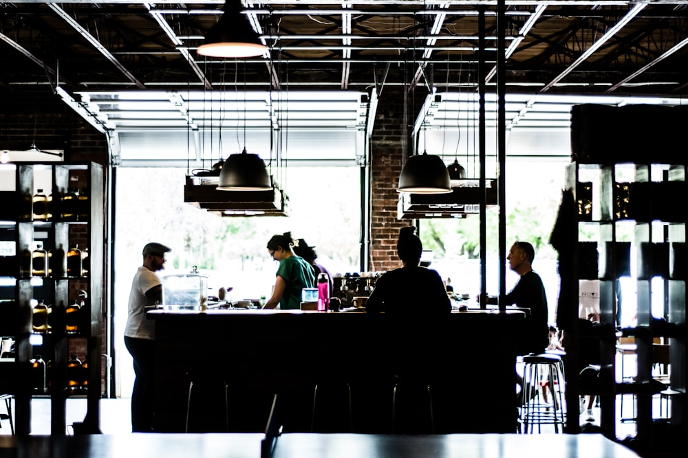 people standing and standing near counter at daytime