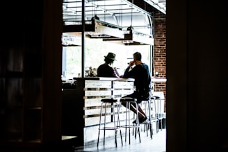 man sitting on bar stool