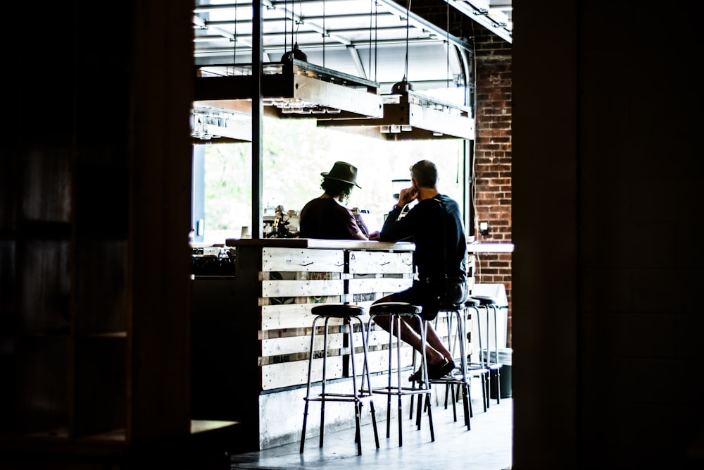 man sitting on bar stool