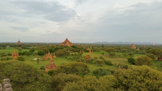 A serene landscape showcasing ancient temples and lush greenery in Bharat.