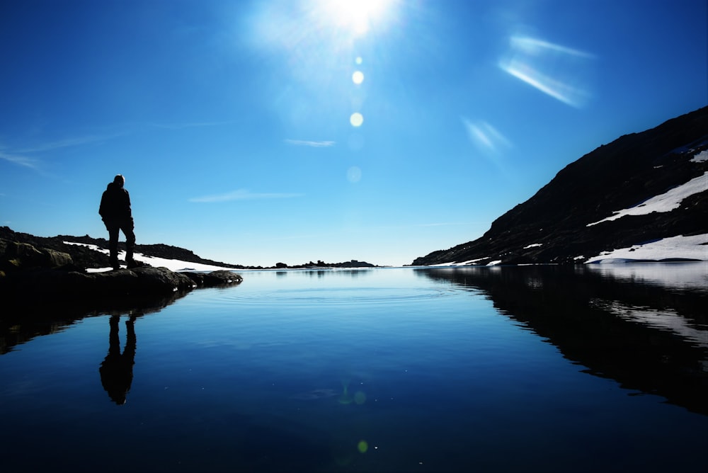 person standing near body of water