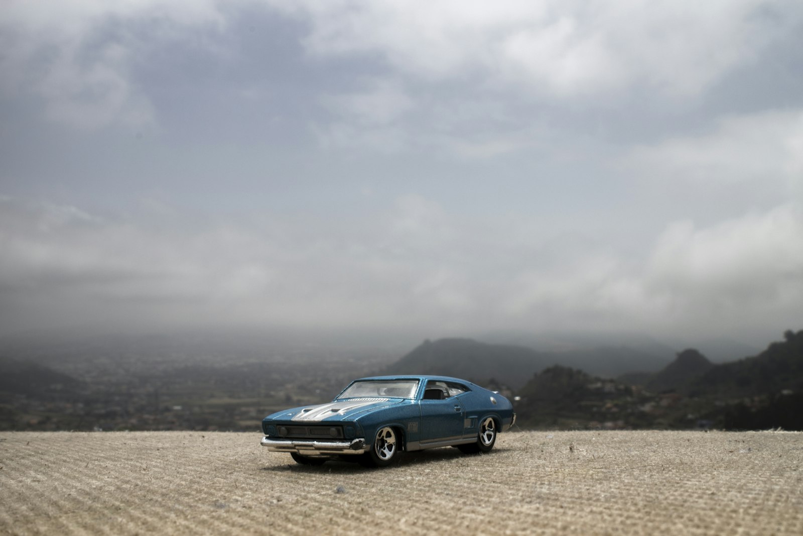 Canon EOS M sample photo. Blue car on field photography