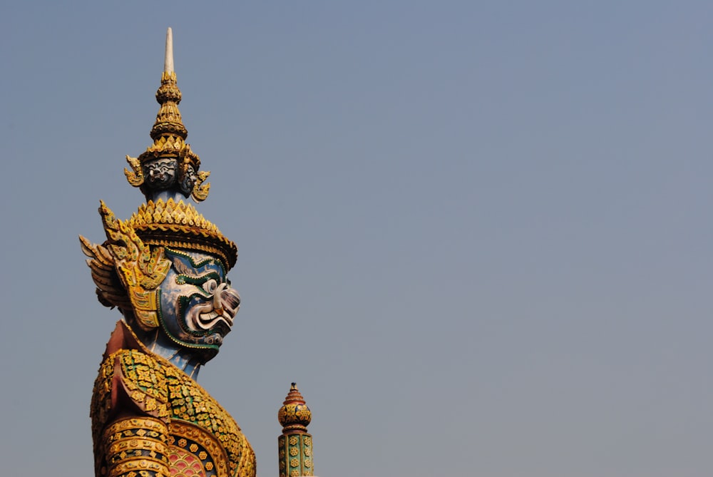 brown and blue Buddha statue