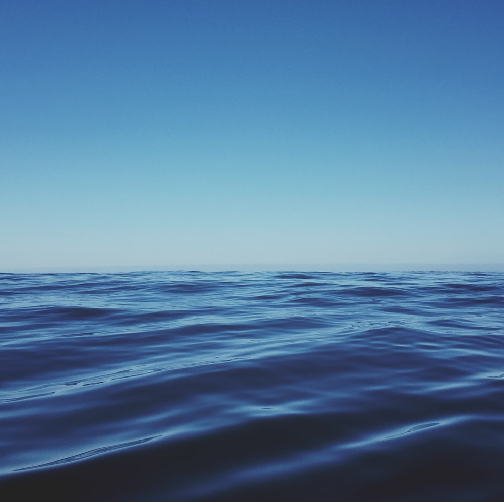 body of water under clear blue sky