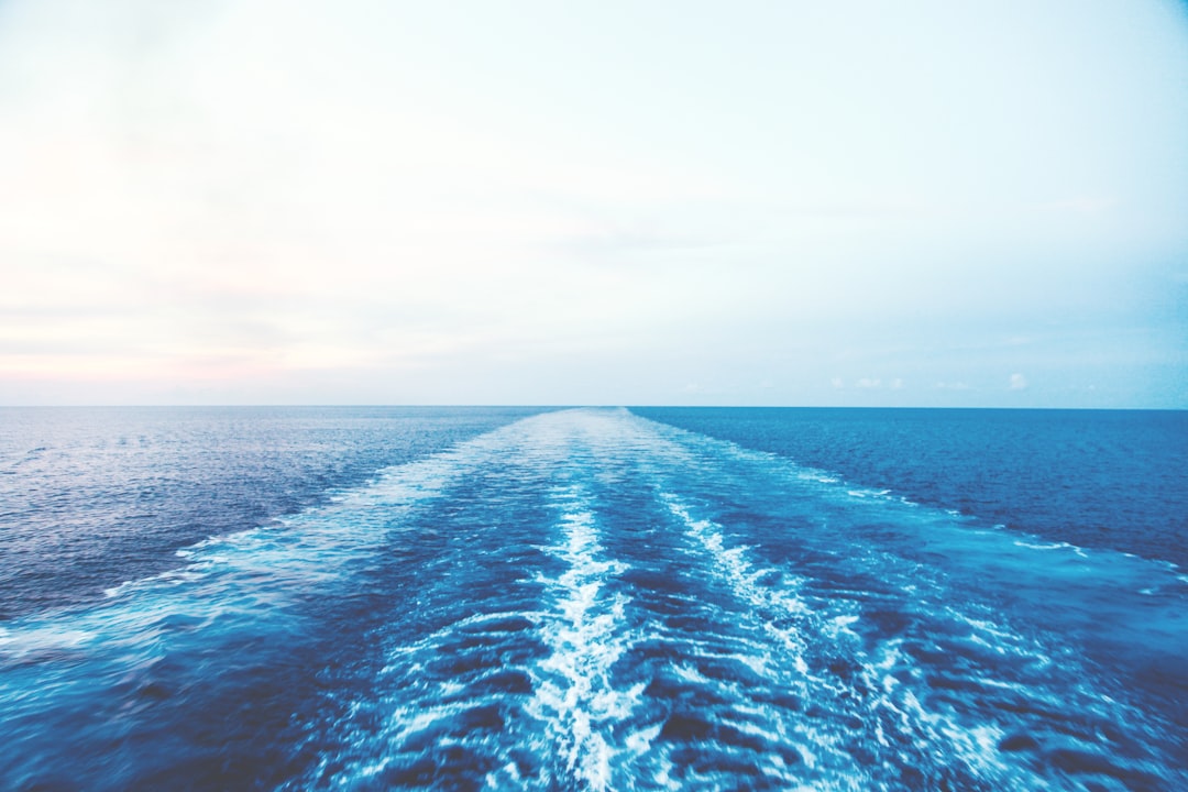 blue ocean water under white sky, 