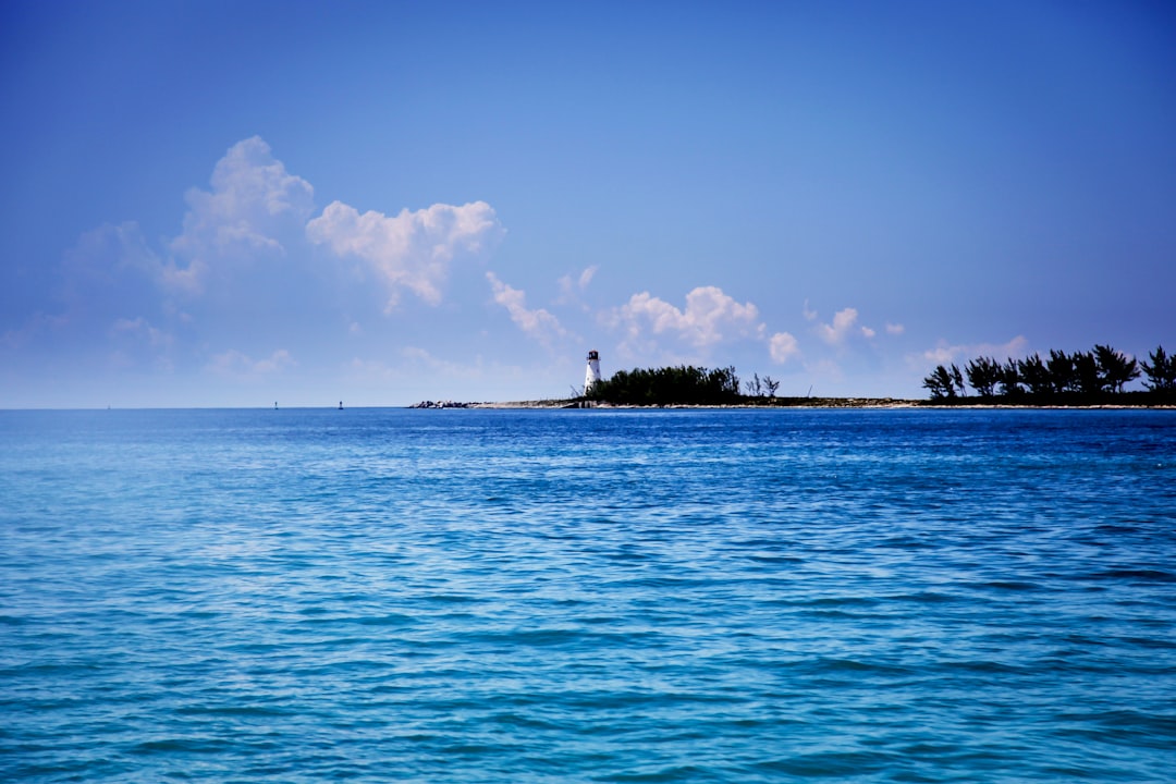 lighthouse under cumulus clouds