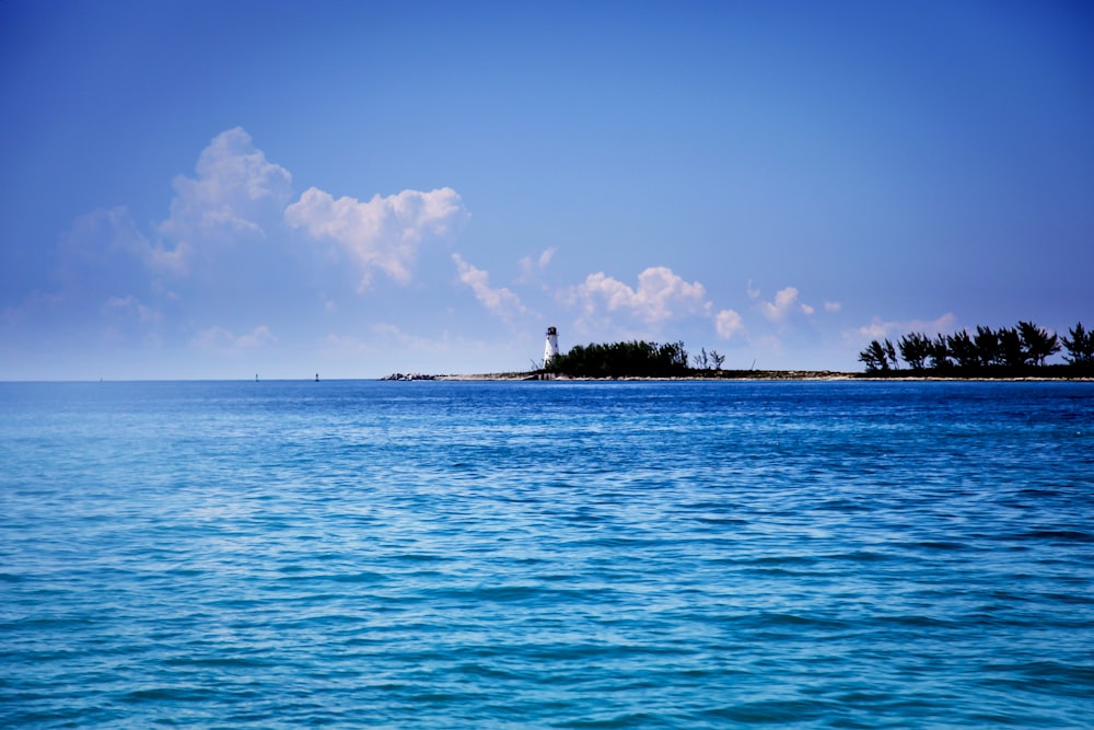 lighthouse under cumulus clouds