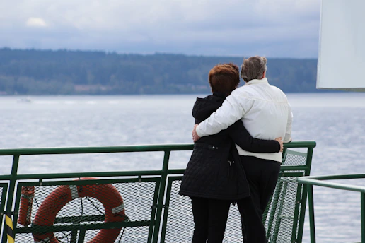 A cheerful senior couple enjoying a scenic sunset on a comfortable travel excursion.