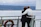Happy couple looking at a cruise ship while holding travel documents