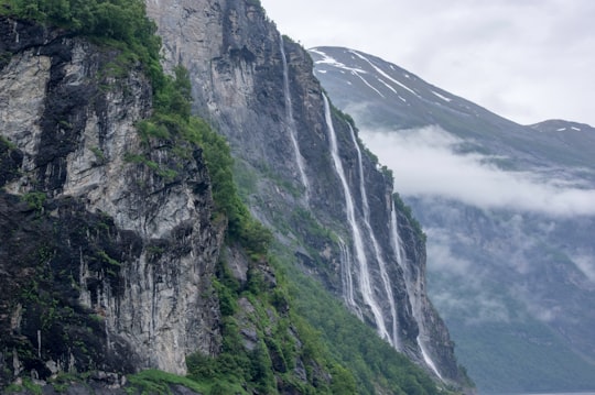 waterfalls through cliffs in Geirangerfjord, Seven Sisters Waterfall Norway