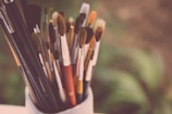 paintbrush lot on paintbrush holder during daytime